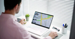 Marketer setting up Google Ads local campaign targeting Newcastle suburbs on laptop