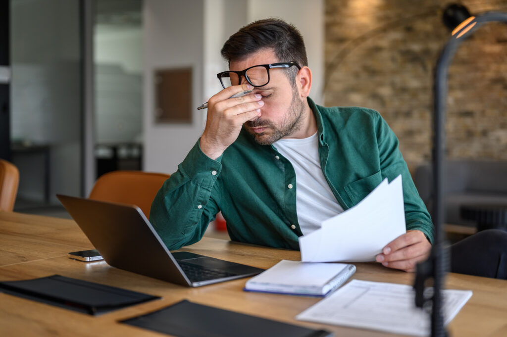 Newcastle business owner reflecting on missed marketing opportunities while looking at laptop
