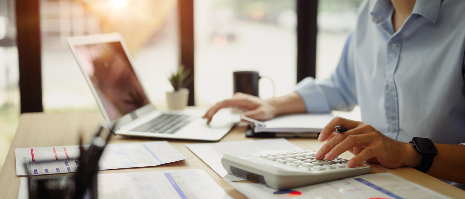 Newcastle business owner calculating Google Ads ROI and CPL using laptop and notes in office setting